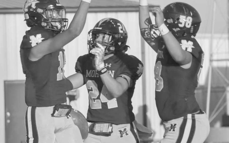 CELEBRATE - Morton Indians Brayden Villarreal, Christian Enriquez and Jorge Regalado celebrated their touchdown in the endzone this past Friday during their homecoming game. (Staff photo by Aalijah Soliz)