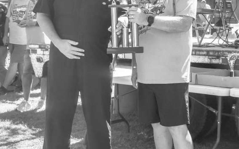 BEST OF SHOW- Pictured is Rich Puryear who won Best of Show with his 1970 Plymouth Superbird. Puryear won $200 dollars and a trophy. The award was presented by Baryy Royal ( Photo courtesy of Emily Campos)