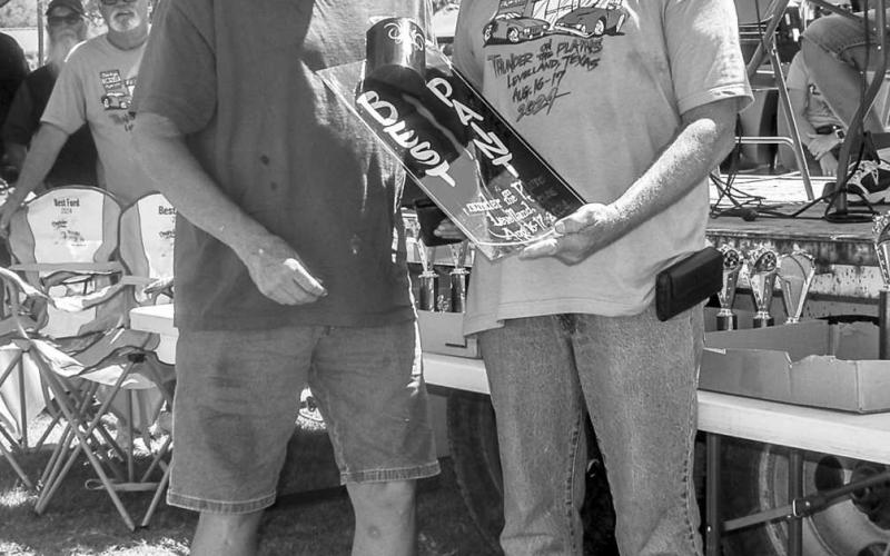 BEST PAINT JOB- Pictured is Otis Shepard who was presented with the Best Paint Job Award by R.H.Reaves at the Thunder on the Plains Car Show on Saturday at the Levelland City Park. Shepard won $100 dollars with his 1956 Chevy Nomad.( Photo courtesy of Emily Campos)