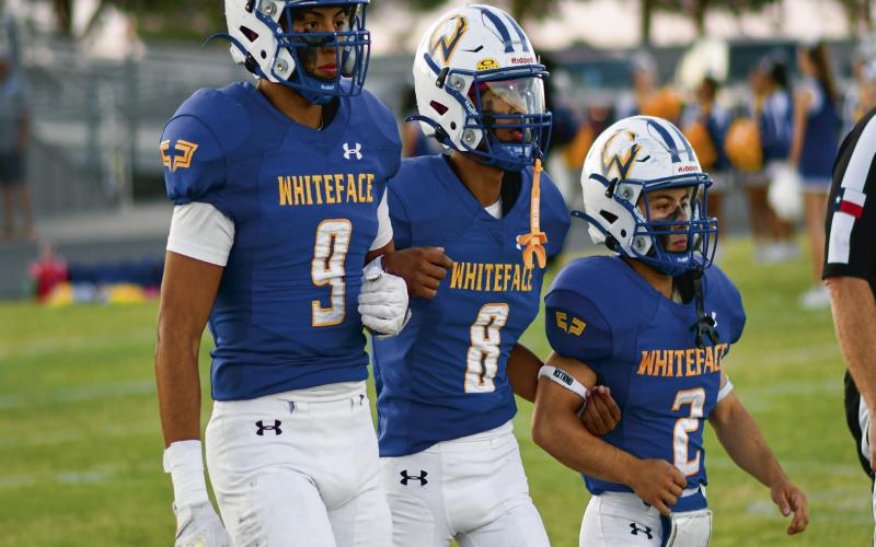 ANTELOPE TEAM CAPTAINS - Whiteface senior football captains pictured from left to right, Axel Rivera, Victor Borunda and Cash Crutcher walk towards the pregame coin toss with their arms linked this past Friday before their Homecoming game against Springlake-Earth. The Antelopes would go on to win 82-48. (Staff Photo by Jentezen Smith)