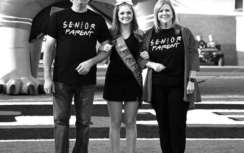 SENIOR CHEER – Levelland seniors were recognized last Friday during the Lobo football home game against the Borger Bulldogs. Senior Brittan Dobson was escorted by her parents Scott and Amee Dobson. (Staff Photo by Dom Puente)