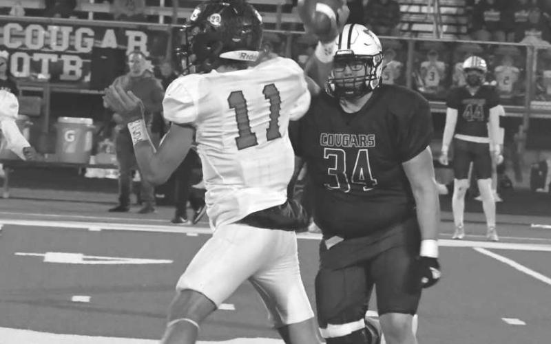 UNDER PRESSURE - Jack Griffin had four carries for 18 yards and went 5-for-13 for 65 yards with a touchdown in a 64-16 Whitharral Panther loss in the area round of the UIL High School 1A-2 Football Playoffs last Friday in Hermleigh. The Panthers finish their season 9-2. (Staff photo by Jay Kelley)