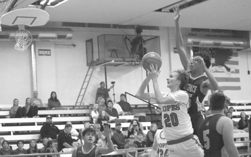 HEADS UP - Ropes Eagle Brennan Bearden layed the ball up with Whiteface Antelope Isaak Soliz giving chase in the Antelopes first game of the season at Ropes. (Staff photo by Aalijah Soliz)