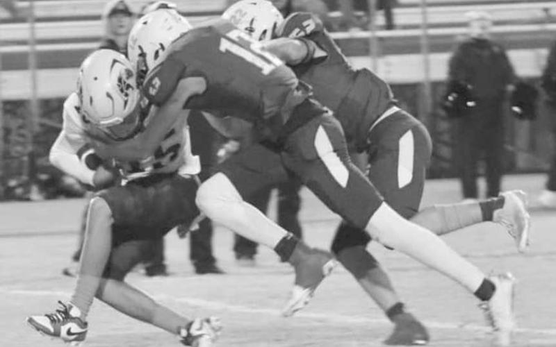 DOWN YOU GO - The Whiteface Antelope defense made short work of the Wellman-Union Wildcats last Friday in a 68-0 home win to start UIL District 3-1A1 high school football action. Pictured are Isaak Soliz (12) and Jaxon Hodge taking down a Wellman-Union runner. The Antelopes faced off against Meadow this past Friday. (Photo by Holly Crutcher)