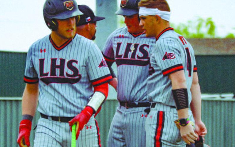 MEETING OF THE MINDS - Levelland Lobos Rusty Johnson, Tyler Pemberton and Brayden Moore gathered around Head Baseball Coach Chris Portwood during the team’s game against Sundown on March 23. (Staff photo)