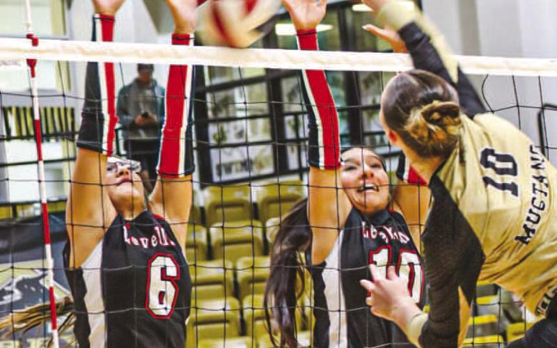 NO EASY SHOTS - Levelland Loboettes Hailiee Estrada and Mia Morin went up to block the Lady Mustangs shot this past Tuesday on the road. (Staff photo by Aalijah Soliz)