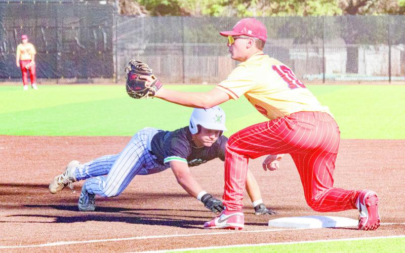 NOPE, NOT TODAY! - Ropes Eagle Jaivyth Cruz easily beats a pick off attempt to first base during their playoff baseball series against West Texas this past weekend at Plainview High School. (Staff photo by Eric Venkatesan)