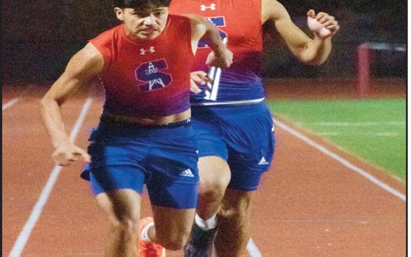RELAY HANDOFF - Sundown’s Josh Hogan hands off to Roland Foster during a relay race. (Staff photo by Eric Venkatesan)