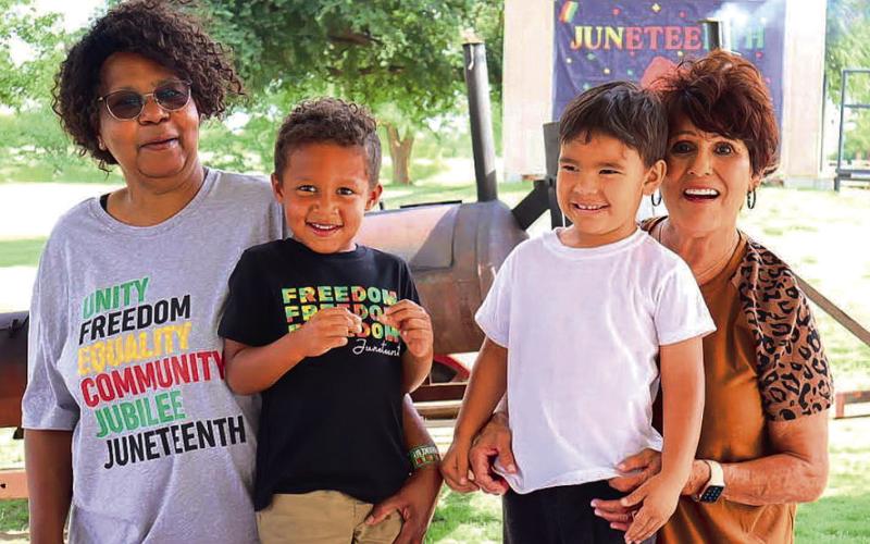 COMMUNITY EXCITEMENT - The 33rd Annual Juneteenth Celebration was held at L.G. Griffin Park in Levelland, June 16-17. The event kicked off Friday, June 16, with kids activities, bingo and dominoes and a Friday night hangout. Saturday, June 17, was slated for the basketball tournament, cookout and cornhole tournament. Pictured is Chris Wade, Bentley Wade, Norma Childers and Jonah Childres setting up the food for the cookout. (Staff Photo by Aalijah Soliz)