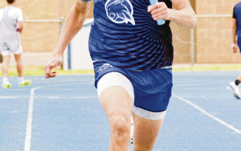 RELAY RUNNER - Smyer Bobcat Colton Burriss sprints with the baton in his hand during a race this past Friday at the Bobcat Relays at Smyer High School. (Staff photo by Eric Venkatesan)