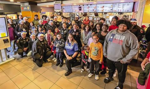 CHRISTMAS SMILES - Kicking off Saturday’s activities for the 2023 Blue Santa event, local law enforcement officers along with 29 children from 17 families enjoyed an early morning breakfast at McDonalds before making their way to Walmart for a little Christmas shopping. Pictured are local law enforcement officers along side the families and McDonalds staff enjoying their Saturday morning. (Photo courtesy of LPD)