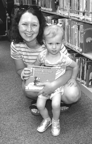 LIBRARY BOOK- Many children participated in the Library Summer Program on Wednesday. They had an opportunity to read and check out library books.Pictured are Penny Bayer and Mikkadee Bayer. (Staff photo by Emily Campos)