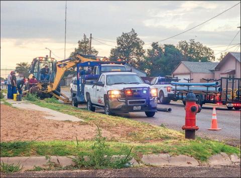WATER LINE WORK - A crew of workers with the City of Levelland were spending their Monday evening working on digging to the necessary water line. The crew was working in front of a residence located on West Avenue and 8th Street. Through traffic on West Avenue was blocked for a period of time requiring vehicles to adjust their routes. (Staff photo by Dom Puente)