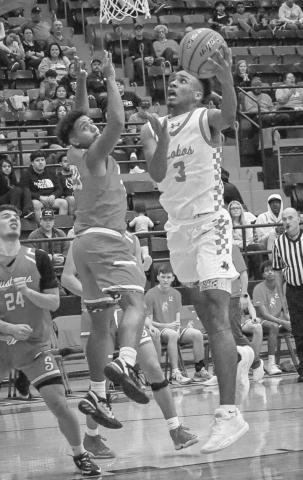 ACROBAT - Levelland Lobo Eryk Jones made a reverse layup during their contest last Tuesday against the Sweetwater Mustangs at home. (Staff photo by Aalijah Soliz)
