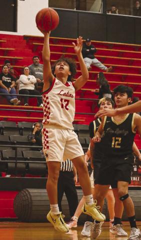 WIDE OPEN - Levelland Lobo Nehemiah Sanchez layed the ball up, getting wide open under the basket during their game against Big Spring. (Staff photo by Aalijah Soliz)