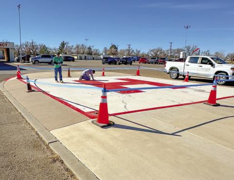READY FOR LANDING - Senior Facilities Technician, Jerry Escamilla and Facilities Technician, Korey Ellibee for Covenant Hospital Levelland took advantage of the warm weather Monday afternoon by renovating the helipad for future incoming flights. (Photo courtesy of Covenant Hospital Levelland)