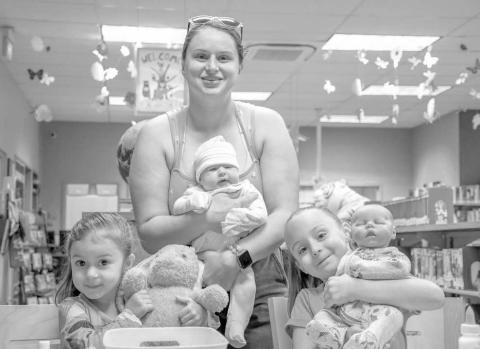 FAMILY FUN - Pictured from left to right are: Maddison, Andrea, and Kelsey Scott who had a fun time as a family during Art and Apples on Wednesday at the Hockley County Memorial Library. (Staff photo by Hannah Woodrum)