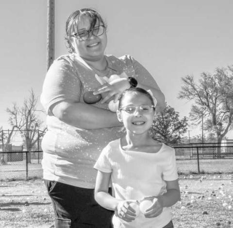 TWO PEEPS IN A POD - Brandie and Marisella Gaona got a sugar rush while searching for Easter eggs this past Saturday at the City Park. (Staff photo by Hannah Woodrum)