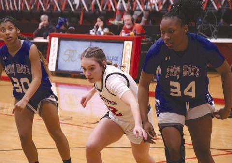 BLOCK OUT- In a nail-bitter of a matchup against the Estacado Lady Matadors, the Levelland Loboette basketball team secured their third straight district championship, 57-51, in overtime. Loboette Emery Smith blocked on a free-throw attempt. (Staff Photo by Dom Puente)