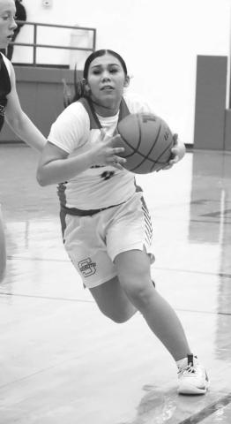 DRIVE IN - Sundown Roughette Yaya Lopez drove the ball in the middle of the New Home defense last Tuesday during their district opener. (Staff photo by Aalijah Soliz)