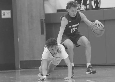 DIVINGATTEMPT - Smyer Bobcat Mason Medart was able to hold onto the ball with Sundown Roughneck Coen Navarez making a diving attempt to steal the ball during the team’s district matchup with each other in Sundown. (Photo courtesy of Sundown ISD)