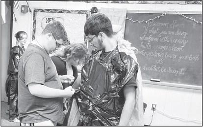 TRASH TO TREASURE: LHS Theater Department designed costumes in Miss Ashley Peikart's class. Students completed their trash to treasure costumes and held a fashion show for several classes. The activity helped students learn the importance of costumes in the theatre world. Pictured in the back are Adisyn Strickland, far left Able Franco, Kendra Karnes in the middle, and Damion Reyes on the right. (Photo submitted by Cristal Isaacks)