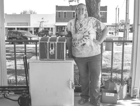 TRESURE CHEST- The Hockley County Library Summer Program had a tresure hunt on Wednesday at the Hockley County Court house lawn. The tresure chest was made possible by the Hockley County Memorial Library. Pictured is the Library Clerk Shawna Carpenter Lopez. (Staff photo by Emily Campos)