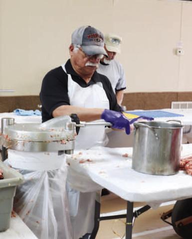 LONGSTANDINGTRADITION - Pictured is Albert Castillo Jr. helping tube the sausage Friday at St. Michael’s Catholic Church. The 40th Annaul Sausage Lovers Festival will be held Sunday, Feb. 16. (Staff photo by Adriana Solis)