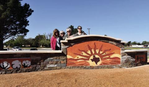 MOSAICART - The Levelland Chamber of Commerce held a ribbon cutting on Tuesday for the Governor’s Community Achievement Award which resulted in a mosaic monument at the southeast corner of Highway 385 and Clubview Drive. Pictured is the artist Pauline Mills and her helpers Kelly Reynolds, Shelly Carver and Nell Elston who spent three months putting the monument together. (Staff photo by Emily Campos)