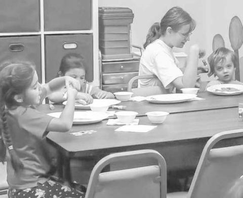 HAVING FUN - Kids were working on their porjects while eating donut holes with their parents. (Staff Photo by Aalijah Soliz)