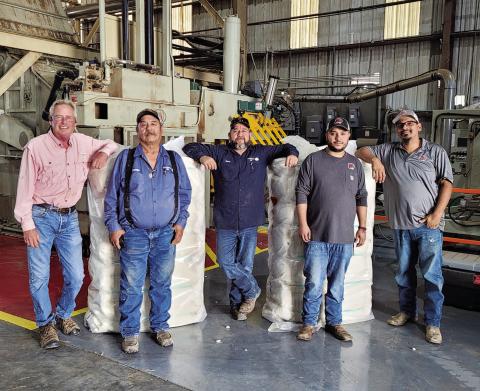 FIRST BALE - Willingham Gin located in Morton is beginning to ramp up work as they put together their first bale of the season in Cochran County. Pictured from left to right are: Gin Manager Todd Willingham, Gin Superintendent Canuto Tarango, Head Ginner Octavio Garay, Gin Helper Jonathon Nava and Head Press Michael Perez. The producer resulting in this seasons first bale was Austin McCasland.(Photo courtesy of Alex Arellano)