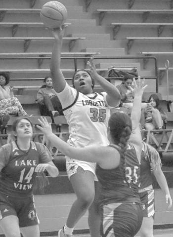 DOWN LOW - Levelland Loboette Sydnii Joyce shot the ball over three Lakeview Maidens during the teams contest last Friday on senior night. (Staff photo by Aalijah Soliz)