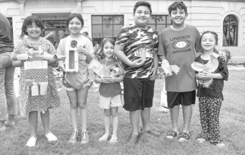 TRASH ART- On Wendesday, the Hockley CountyLibrary Summer Reading Program had children in attendance turn trash in to art. Pictured from left to right are: Davennee Aubree Declan, Alivia, Aubree, and David Jaramillo. (Staff photo by Emily Campos)