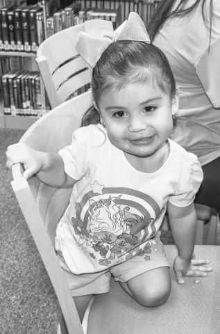 TIME AT THE LIBRARY - Rosalyn Torres is starting her love for reading young by participating in the Hockley County Library Summer Program this past Wednesday. Torres spent time with her sister, uncle and aunt at the library. (Photo courtesy of Emily Campos)