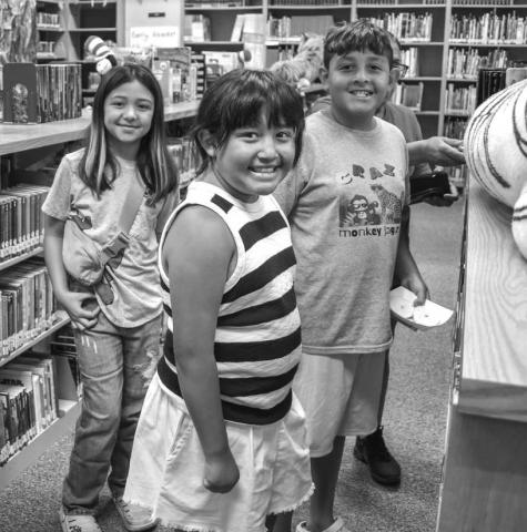 SEARCH FOR A GOOD BOOK - The Hockley County Library continues to have its summer program on Wednesdays at the library. Pictured is: Davenee, Aubree and Declan Jaramillo who participated in the reading program on Wednesday. The three took their time looking for books they liked after the program activities. (Photo courtesy of Emily Campos)