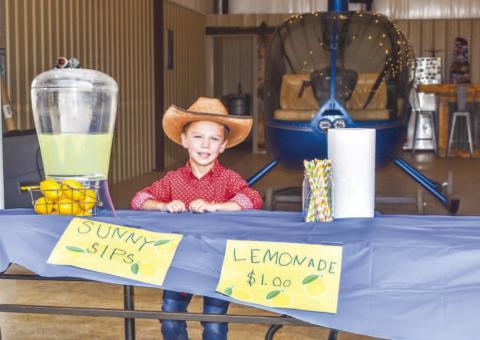 SUNNY SIPS LEMONADE- Wyatt Dunn was out selling lemonade on Wednesday. Dunn spent his own money to buy the lemonade, lemons, cups and straws it coast $1 a cup. Dunn said he hopes to sell enough lemonade to buy a house boat to put out at Possum Kingdom Lake. (Photo courtesy of Emily Campos)