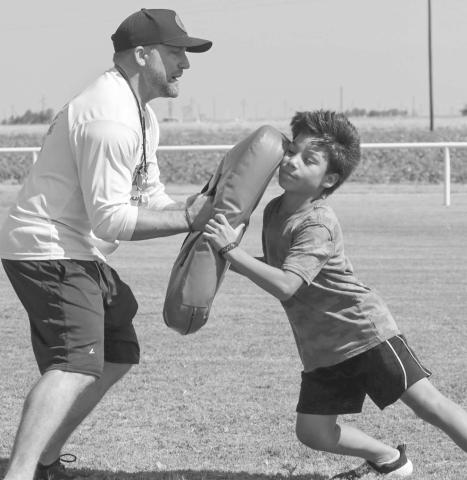 BLOCKING - Head Football Coach Jeremy Holt taught Panther Thiago Rendon hand placement for blocking on the pads this past Monday at the Whitharral Football Field. (Staff photo by Aalijah Soliz)
