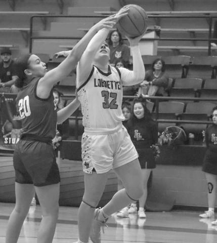 TOUGH SHOT - Levelland Loboette Emery Smith layed the ball up through the contact during the team’s game against Snyder at home during their Senior Night. (Staff photo by Aalijah Soliz)