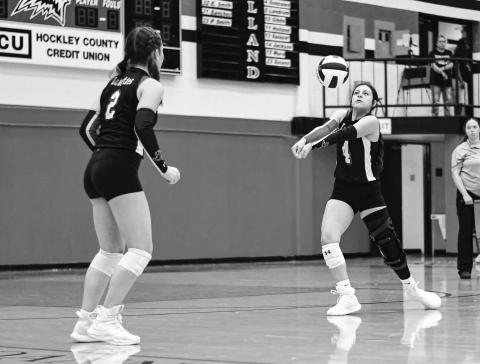 BRACE FOR IMPACT – Senior Yara Carrillos gets in position to play the volleyball while freshman teammate Lola Potter watches during a match at home against Abernathy this past Tuesday. (Staff photo by Jentezen Smith)