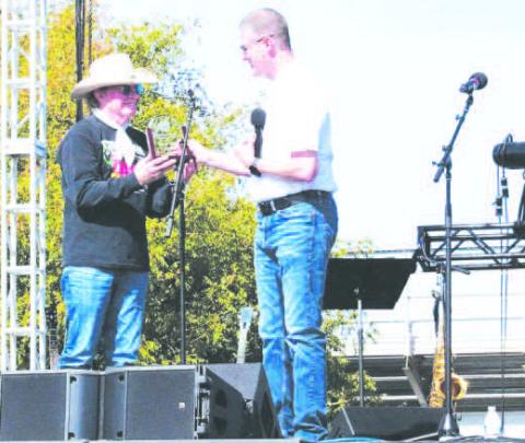 2025 DISTINGUISHEDALUMNI- South Plains College President Robin Satterwhite (right) presents the 2025 Distinguished Alumni Award to country music artist Gary P. Nunn during the SPC Creative Arts Department’s 50th Anniversary Celebration on Nov. 1. Established in 1987, the award honors outstanding alumni who have made significant contributions to their community. (SPC Photo)