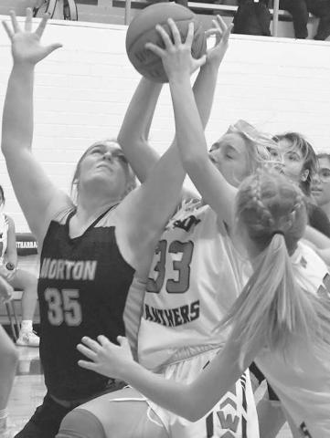 REBOUND BATTLE- Whitharral’s Avery McCain and Morton’s Kayleigh Boggs fought for a rebound last Tuesday in girls’ high school basketball action in Whitharral. The final score was 31-28 Whitharral, but the game goes down as a forfeit as Whitharral is playing a junior varsity schedule due to numbers. The Whitharral girls will be in Cotton Center on January 3. (Photo by Jay Kelley)