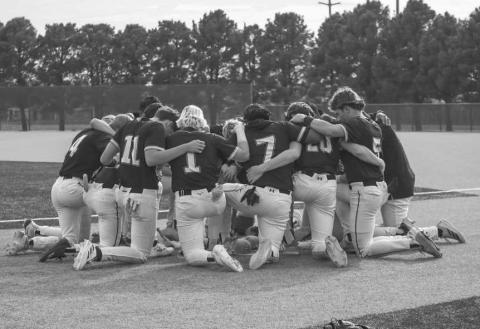 PRAY - The Ropes Eagles prayed before their game against the New Deal Lions this past Thursday night at the Littlefield Baseball Field. (Staff photo by Aalijah Soliz)