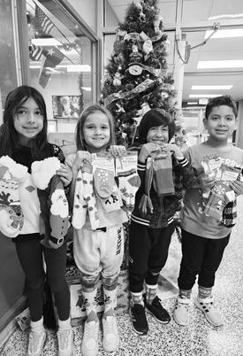 Capitol kids enjoyed Cozy Winter Day. The kids got to wear cozy socks and donate a pair of cozy socks to the local senior citizens. Pictured from left to right are Arysai Reyes, Makenzie Del Campo, Nicholas Garza, Arturo Erreguin. (Photo submitted by Cristal Isaacks)