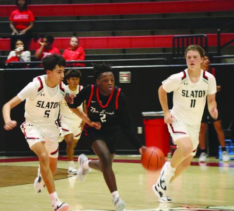 DOWNHILL - Levelland Lobo Elijah Jordan brought the ball down the court to break the Slatons press defense during the teams game Nov. 17. (Staff photo by Aalijah Soliz)