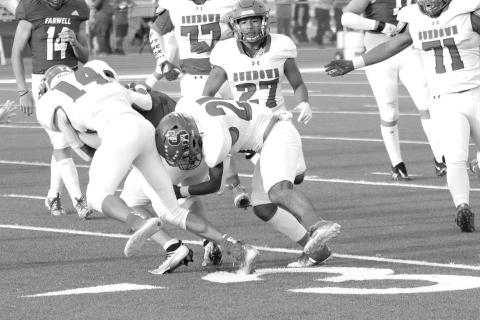 LOSS OF YARDS- The Sundown Roughnecks fell to Farwell, 49-0. Koy Torres and Ricky Melendez work together to bring down a Farwell player for a loss of yards. Sundown will welcome Wink into for homecoming Friday September 16. Kick is scheduled for 7:30 p.m. (Photo Courtesy of Chris Bratcher)