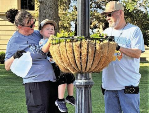 DRINK UP- Community members worked this past Saturday cleaning out planters containing the spring plants and adding live plants for the summer months. (City of Levelland Main Street photo)