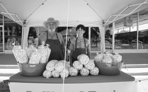 POPCORN TIME - During the First Saturday at the Square event held by the Main Street Program in downtown Levelland, Lolli and Pops Kettle Corn had their booth ready to sell Levelland community members their product. Pictured is Brian Langdon and Asher Leal getting ready for the event to sell their kettle corn. (Staff photo by Aalijah Soliz)