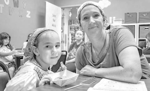 BOOKS AND BAGELS – Pictured is Willow Verner and Melanie Anderson at the Books and Bagels event held at the Hockley County Memorial Library on Wednesday. Kids and parents were able to color in coloring books made by the library and enjoy a bagel. (Staff photo by Ada Niederhauser)