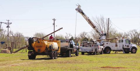 MAKING REPAIRS - A K-BAR Electric crew was pictured early in the week working on a city water well after its power pole had been damaged due to the severe storm on May 29. Electric companies have been working around the clock to repair damaged power poles and lines that were affected by the storm. (Staff photo by Emily Campos)