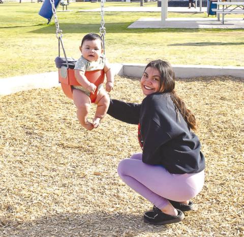FUN IN THE SUN - Kayla Chavez and her daughter Royalty Gutierrez enjoyed their time playing on the swings at Bartlett Park Monday afternoon. Bartlett Park also includes a two playground areas, a wide-open grass area, a basketball area, a pavillian and recently installed Gaga Ball area. Bartlett Park is one of 13 parks and 14 playgrounds that span the City of Levelland. (Staff photo by Emily Campos)